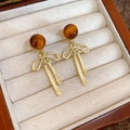 Detail of bow-shaped golden earrings with amber tiger-eye resin beads in a jewelry box - 38# Bow & Amber Brown Bead Earrings (925 Sterling Silver Earring Post)