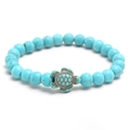 Blue turquoise bead stretch bracelet with a bronze-finish metal sea turtle charm - Blue Turquoise (NL04-4)