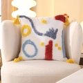 Square tufted rainbow pillow with colorful embroidery and yellow tassels on a cozy white chair - Tufted-Color Impression (Cover Only) / 18x18 Inch