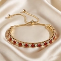 Macro view of adjustable gold tennis bracelet with alternating red and clear crystals - Gold Red and White Zircon (B0101G-4)