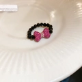 Black beaded star ring set with pink rhinestone bow detail on white ceramic plate - Black Pink Bowknot Beaded