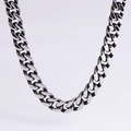 Macro view of polished silver Cuban link chain with detailed black oxidized finish - 9.5mm Vintage Silver