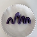 Glossy purple wave hair claw clip in resin finish displayed on a white ceramic plate - Fog Purple