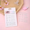 Iridescent face gems and 3D nail art stickers with teardrop and flower shapes on pink background - Small Flower White