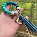 Macro detail of silicone beaded keychain with blue leather tassel and gold ring - Style 3-Navy Cyan Marble White/Navy Tassel