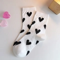 Mid-calf white cotton socks featuring all-over black heart patterns for women - One Size / White With Black Heart