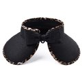 Detail of black straw visor hat featuring leopard print trim and a large woven bow decoration - Black