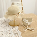 Close-up of beige straw hat and matching bag with white daisy decor on a lace tablecloth - 54cm / Hat + Bag Set / Beige