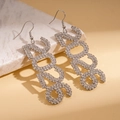 Macro shot of silver 2023 number earrings with sparkling rhinestones on marble stone - Ear Hook-Silver (2023)