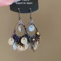 Boucles d'oreilles vintage en bronze avec perles mauves et disques de coquillages - Style Coquille Évidée en Bronze / Blanc