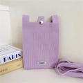 Detail view of the soft lavender knitted texture and fabric strap on a mini crossbody phone bag - Purple