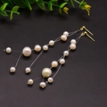 Elegant 18k gold plated long fringe earrings with natural freshwater pearls on black background - Magic Pearl / White
