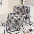 Close-up of bohemian knit blanket with evil eye pattern and fringe on a rattan chair - Evil Eye Colorful / 160*130CM