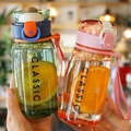 Pair of minimalist transparent plastic water bottles in pink and green with carrying straps - Green + Pink