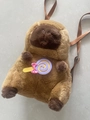 Brown Capybara plush backpack with a lollipop decoration and pink bow details - Capybara Lollipop Style / 30cm