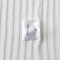 Detail shot of the 100% viscose ribbed fabric and size label on the white knit dress - S / Off White