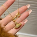 Golden titanium necklace featuring a sparkling crystal-encrusted planet orb and safety pin pendant - 383 Gold Necklace