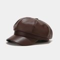 Detail shot of a dark brown leather octagonal newsboy hat with stitched panels and top button - One Size / Dark Brown