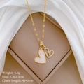Double-layered gold heart pendant necklace with shimmering crystals on white silk - Gold Double Heart Micro-inlaid Style