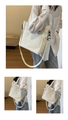 Detail showing the white tote bag adjustable strap and front pocket on model - White