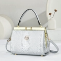 Close-up of silver snakeskin textured handbag with premium gold hardware and logo - Snake Pattern Silver