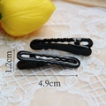Detail view of black metal hair clips measuring 1.2cm by 4.9cm on lace background - 1.2x4.9cm / Black-Wave