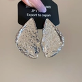 Macro detail of silver geometric earrings with irregular hammered metal texture on card - Irregular Triangle (925 Sterling Silver Earring Post) / Silver
