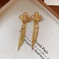 Elegant gold flower tassel earrings with teardrop crystal and long snake chains - Gold Flower Waterdrop Tassel Style