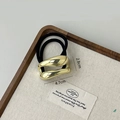 Minimalist gold oval metal hair tie with black elastic band on wooden tray - Gold Lip Shape Double Rope
