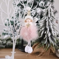Pink plush Christmas angel ornament with golden snowflake hanging on a white branch - Pink Feather Angel Pendant