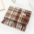 Close-up of brown and beige plaid cashmere scarf featuring soft fringe and quality tag - Grid Dark Coffee