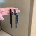 Detailed view of elegant black crystal tassel earrings with a geometric knot design - Knot Style / 925 Silver Needle / Black