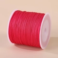 Roll of high-saturation 0.8mm red nylon cord on white spool for DIY hand weaving - Azalea