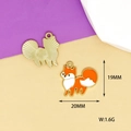 Detail of fox enamel charms showing front orange pattern and gold textured back - Fox