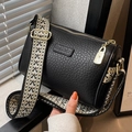 Classic black litchi texture cylinder crossbody bag with stylish geometric woven strap - Black