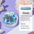 Ocean scented soy shell candle with blue sequins and dried flower crystals in clear jar - Dried Flower Glitter / Blue / Ocean