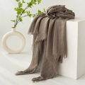 Brown linen scarf with frayed edges draped on a white cube for a soft natural aesthetic - Stone