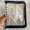 Transparent jewelry storage book with black fabric edge holding gold earrings and pins - Black Silver 3-inch 160 Slots + 50 Bags