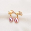 Elegant gold ginkgo leaf earrings with pink purple freshwater pearls on beige silk fabric - Pink Purple Ginkgo Leaf