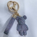 Detailed macro view of purple sparkling rhinestone bear keychain with crystal woven strap - Iridescent Light Purple