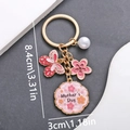 Mother's Day keychain with pink butterfly, flower and pearl charm in gold finish - Pink (ER702)