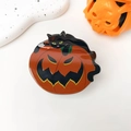 Macro detail of acrylic Halloween hair claw clip featuring a black cat on an orange pumpkin - Halloween Cat on Pumpkin - 7cm Orange Black