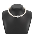 Elegant white pearl necklace with a silver heart pendant on a black bust mannequin - Silver