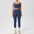 Detail of navy blue high-waist yoga leggings and strap sports bra set in matte finish - S / Navy Blue