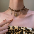 Brown leather necklace with sun and moon pendants featuring tiger eye stone on model - Vintage Cross Sun Moon Necklace Style (6273)