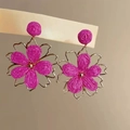 Detail of vibrant magenta chiffon flower earrings with golden metal petals and accents - Rose Red