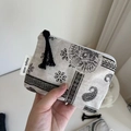 Close-up of paisley canvas coin purse with black tassel zipper and side label - Paisley Geometric