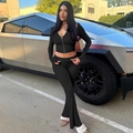 Detail of black zip-up hoodie and high-waisted flared pants set on a female model - XS / Black