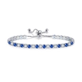 Detail of adjustable silver tennis bracelet featuring alternating blue and clear cubic zirconia - Adjustable / White Gold + White Blue