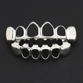 Polished silver-colored hollow frame teeth grillz set on a black leather background - Hollow Style Set / Middle 4 Hollow Flat Tooth Silver Set